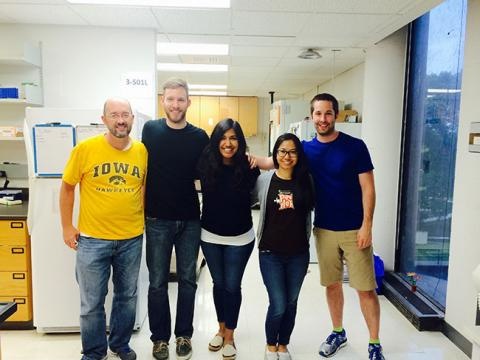 Five lab members in the lab, smiling