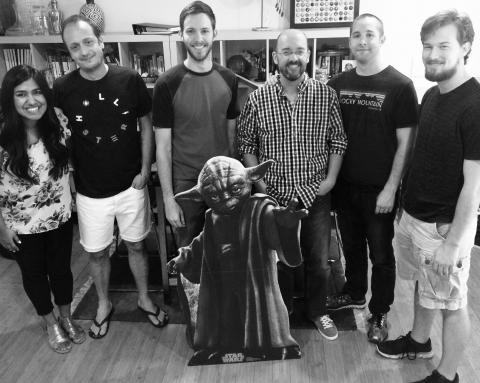 Six lab members and a cardboard standee of Yoda smiling