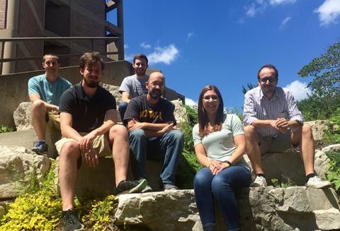 Lab members sitting on rocks outside the Bowen Science Building