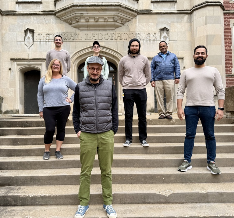 Badovinac Lab members standing on the steps of the Med Labs building with hands in pockets, looking cool