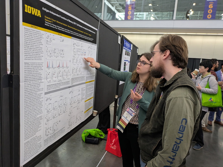 Two people looking at a research poster